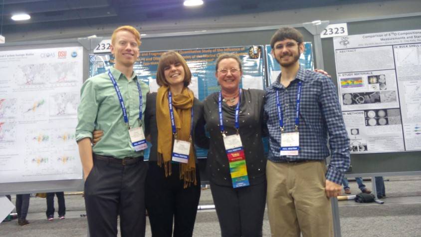 Cole Vickers, Brittany Ward, Figen Mekik and John Howlett standing in front of a project board
